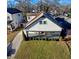 Charming two-story home featuring a cozy front porch, complemented by a well-maintained lawn and mature trees at 1583 Elixir Sw Ave, Atlanta, GA 30314