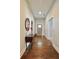 Inviting foyer with hardwood floors, neutral wall color, console table with decorative mirror and well lit at 1583 Elixir Sw Ave, Atlanta, GA 30314