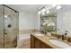 Bathroom with double sinks, granite countertops, and a glass enclosed shower and separate tub at 2173 Lebaron Ne Dr, Atlanta, GA 30345