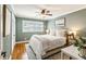 Cozy bedroom featuring neutral green walls, plantation shutters, and a ceiling fan with lighting at 2173 Lebaron Ne Dr, Atlanta, GA 30345