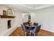 Cozy dining area features brick fireplace, hardwood floors, and plenty of natural light at 2173 Lebaron Ne Dr, Atlanta, GA 30345