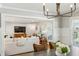 Open-concept living room with a view into dining area with hardwood flooring and natural light at 2173 Lebaron Ne Dr, Atlanta, GA 30345