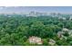 Aerial view of home showing roof, surrounding trees, and city skyline in the background at 2983 Habersham Nw Ct, Atlanta, GA 30305