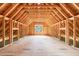 Spacious unfinished attic featuring exposed beams and wooden framing with a window view at 2983 Habersham Nw Ct, Atlanta, GA 30305