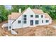 Stunning white brick home boasts wood shingle roof, modern windows, and sophisticated architectural design at 2983 Habersham Nw Ct, Atlanta, GA 30305