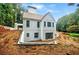 Rear exterior of home showing the white brick, multi-level design, and surrounding wooded area at 2983 Habersham Nw Ct, Atlanta, GA 30305