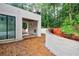 Modern white brick home exterior under construction with a retaining wall and surrounded by lush greenery at 2983 Habersham Nw Ct, Atlanta, GA 30305