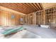 Image of the bare studs of the garage showing the oval window and supplies on the floor at 2983 Habersham Nw Ct, Atlanta, GA 30305