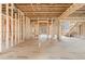 View of the living room, showing the open-concept design, bare studs, ceiling, flooring, and staircase at 2983 Habersham Nw Ct, Atlanta, GA 30305