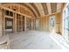 Spacious living room featuring exposed framing, large windows, and high ceilings under construction at 2983 Habersham Nw Ct, Atlanta, GA 30305