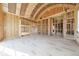 Bare stud framing of the living room shows a vaulted ceiling with plenty of natural light coming through the windows at 2983 Habersham Nw Ct, Atlanta, GA 30305