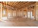 Spacious living room shows the bare studs, ceiling and flooring of this unfinished space at 2983 Habersham Nw Ct, Atlanta, GA 30305