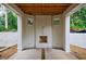 Under-construction white brick patio with an outdoor fireplace, concrete flooring, and exposed wooden beam ceiling at 2983 Habersham Nw Ct, Atlanta, GA 30305