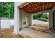 Covered outdoor patio under construction featuring white brick walls, fireplace, and open access to backyard at 2983 Habersham Nw Ct, Atlanta, GA 30305