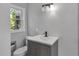 Modern bathroom with gray vanity, updated fixtures, and a toilet at 4373 Sun Valley Blvd, Atlanta, GA 30344