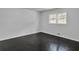 This bright bedroom offers gleaming hardwood floors, fresh white walls, and double-paned windows at 4373 Sun Valley Blvd, Atlanta, GA 30344