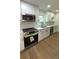 Bright kitchen features stainless appliances, white cabinets, and a double basin sink at 4373 Sun Valley Blvd, Atlanta, GA 30344