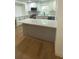 This kitchen has white cabinets, a marble countertop island, and stainless appliances at 4373 Sun Valley Blvd, Atlanta, GA 30344
