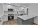 This kitchen features white cabinets, a gray island, and stainless steel appliances at 4373 Sun Valley Blvd, Atlanta, GA 30344