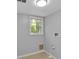 Bright laundry room with window, neutral paint, and tile flooring at 4373 Sun Valley Blvd, Atlanta, GA 30344