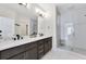 Modern bathroom with dual sinks, large mirror, and walk-in shower with stylish tile at 1181 Rambler Cross, Atlanta, GA 30312