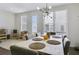 Cozy dining area with natural light and modern chandelier, adjacent to play area at 1181 Rambler Cross, Atlanta, GA 30312