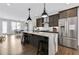 Modern kitchen with stainless steel appliances, dark cabinets, marble countertops and an island with bar seating at 1181 Rambler Cross, Atlanta, GA 30312