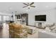 Bright living room featuring hardwood floors, modern lighting, comfortable seating, and an open layout to the kitchen at 1181 Rambler Cross, Atlanta, GA 30312
