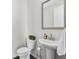 Modern powder room with pedestal sink, decorative mirror, and stylish fixtures at 1181 Rambler Cross, Atlanta, GA 30312
