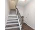 Staircase featuring dark wood treads, white risers, and a sleek metal railing at 1181 Rambler Cross, Atlanta, GA 30312