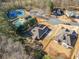 An aerial view of the property showcasing the house and community amenities, like tennis courts and pool at 153 Newcastle Walk, Woodstock, GA 30188