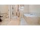 Bright bathroom with shower, bath, and tile flooring at 153 Newcastle Walk, Woodstock, GA 30188