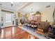 Formal dining room showcasing wood floors, chandelier, and natural light, setting the stage for memorable meals at 153 Newcastle Walk, Woodstock, GA 30188