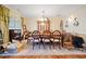Spacious dining area features hardwood flooring, elegant chandelier, and ample space for gatherings, offering an inviting ambiance at 153 Newcastle Walk, Woodstock, GA 30188