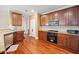 A bright kitchen with stainless steel appliances and a view of hardwood floors at 153 Newcastle Walk, Woodstock, GA 30188