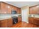 Kitchen featuring brown cabinets, granite countertops, a gas stove, and stainless steel microwave at 153 Newcastle Walk, Woodstock, GA 30188
