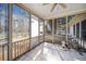 Enjoy the outdoors in this screened in porch with tile flooring and ceiling fan at 153 Newcastle Walk, Woodstock, GA 30188