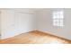 Bright bedroom features a closet, hardwood floors, and a sunlit window view at 3077 Colonial Way # F, Atlanta, GA 30341