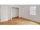 Bedroom includes hardwood floors, closet, and a window view at 3077 Colonial Way # F, Atlanta, GA 30341