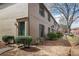 Exterior view of a brick townhouse with green trim, a green front door, and manicured landscaping at 3077 Colonial Way # F, Atlanta, GA 30341