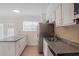 Well-lit kitchen with granite countertops, stainless steel appliances, and french doors at 3077 Colonial Way # F, Atlanta, GA 30341