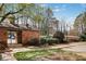Charming brick pool house with a gated entrance leads to a pool area with mature trees at 3077 Colonial Way # F, Atlanta, GA 30341
