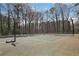 Outdoor tennis court surrounded by a forest, offering a private and scenic recreation space at 3077 Colonial Way # F, Atlanta, GA 30341
