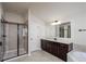 Modern bathroom features walk-in shower with glass door, dark wood cabinetry, and framed mirror at 3815 Pleasant Woods Dr, Cumming, GA 30028