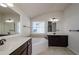Elegant bathroom with dual vanities, soaking tub, dark wood cabinetry, and tiled floors at 3815 Pleasant Woods Dr, Cumming, GA 30028