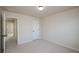 Neutral bedroom features a door to the hallway and a closet door at 3815 Pleasant Woods Dr, Cumming, GA 30028