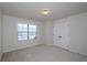 Bedroom with neutral carpet, double closet, and window offering natural light at 3815 Pleasant Woods Dr, Cumming, GA 30028