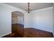 Bright dining room featuring hardwood floors, archway, and chandelier at 3815 Pleasant Woods Dr, Cumming, GA 30028
