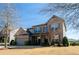 Two story home has a brick front and neutral siding on a large lot at 3815 Pleasant Woods Dr, Cumming, GA 30028