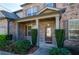 Inviting covered front porch with brick columns and manicured bushes at 3815 Pleasant Woods Dr, Cumming, GA 30028